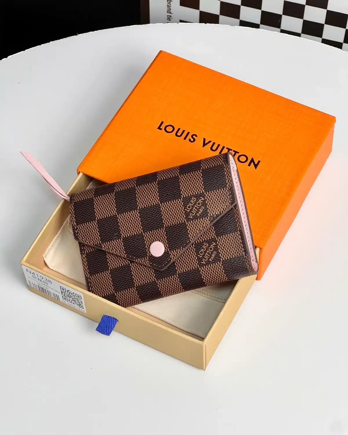 product-louis-vuitton-victorine-tri-fold-wallet-damier-ebene-pink-front-1200x1500-03-tbd