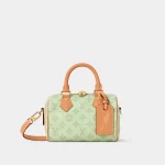 Signature Boston Bag 20 in sand toned monogram canvas with wide strap front view