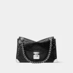 Signature Soft Trunk shoulder bag in black calfskin leather with gold studs front view
