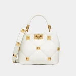 Signature Macro Stud Top Handle Small bag in quilted nappa leather front view