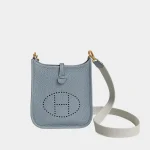 Signature Perforated Crossbody Mini in flax blue leather with grey strap front view
