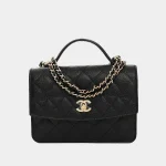 Signature Top Handle Chain Clutch in black grained leather with gold plate front view
