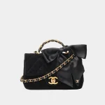Signature Velvet Top Handle Mini bag in black velvet with gold hardware front view